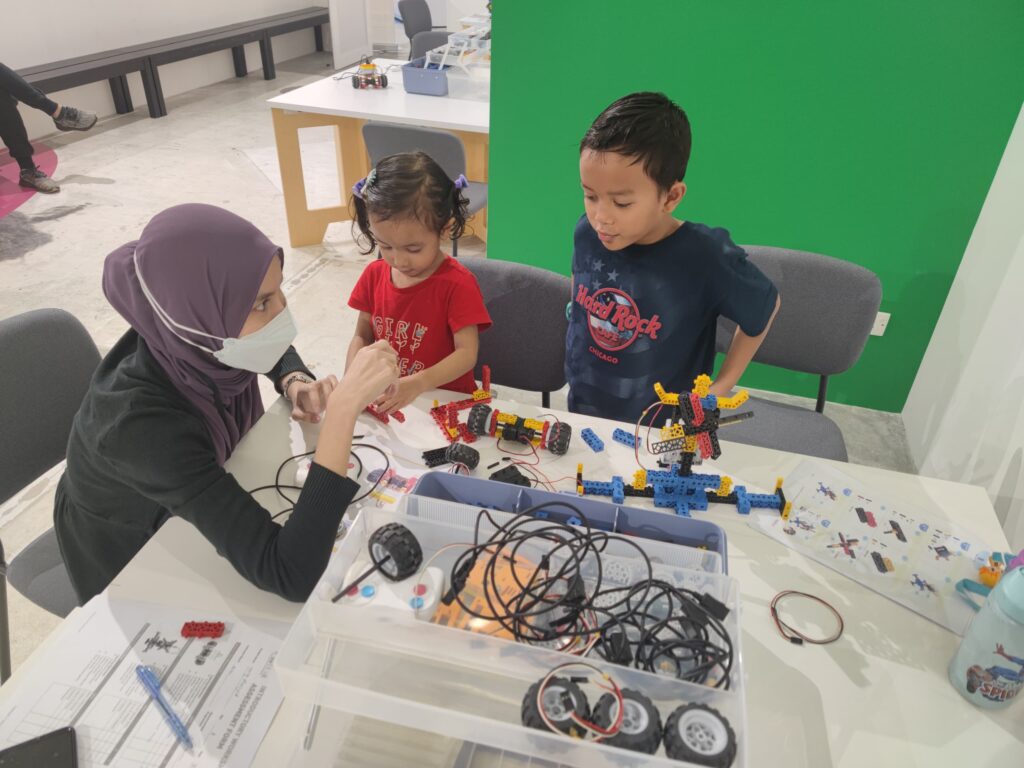 Instructor teaching robotics at a workshop to children